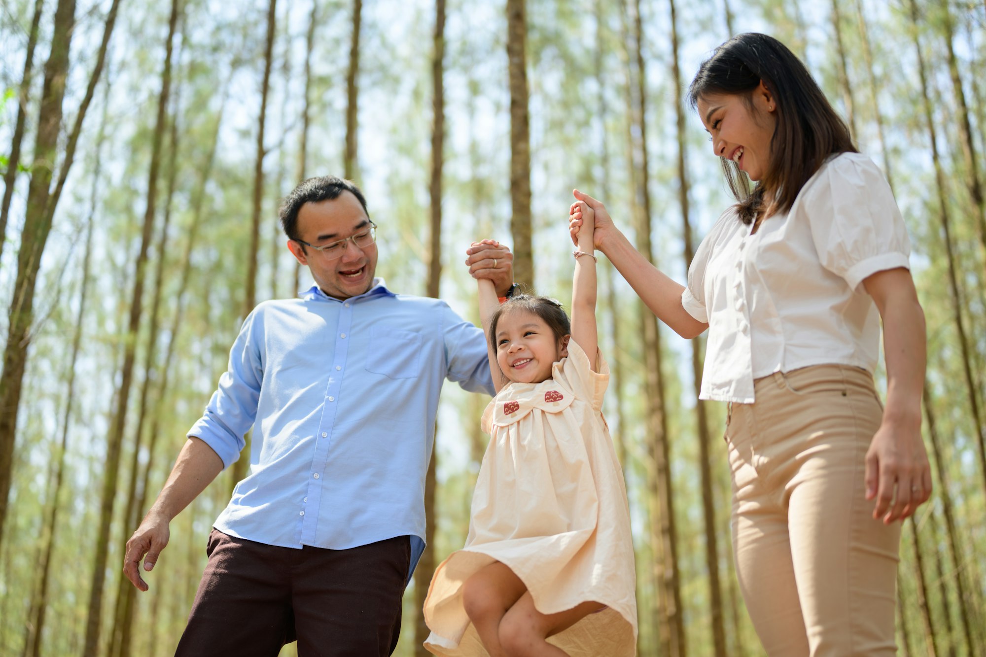 Happy family having fun with summer trip in park together on weekend