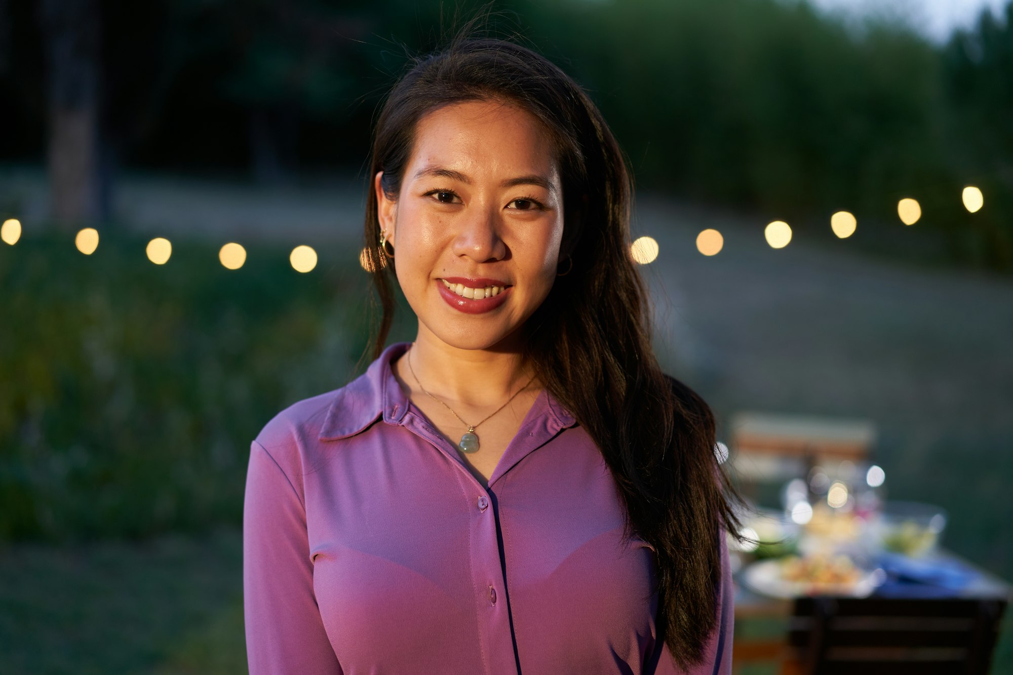 Portrait of an asian woman looking at the camera. Chinese female at restaurant with a nice smile