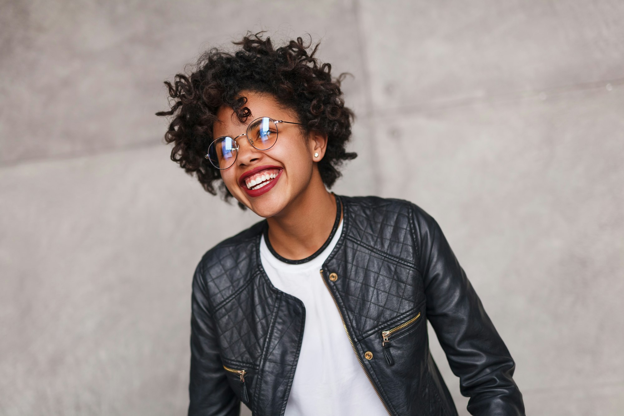 Stylish black teenager cheerfully laughing